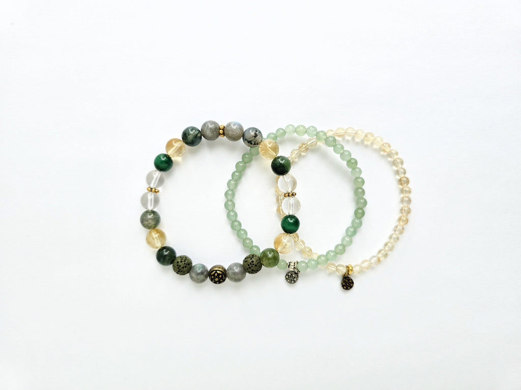 Set of three beaded bracelets on a white background