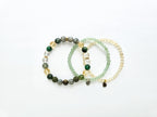 Set of three beaded bracelets on a white background