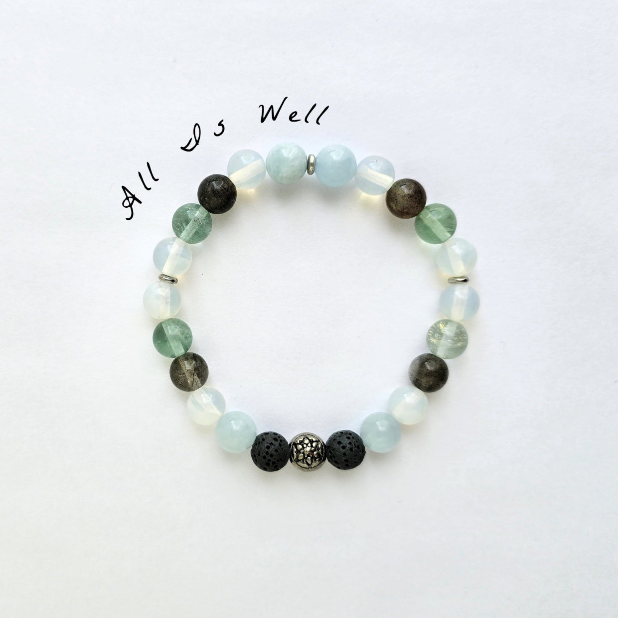 Beaded bracelet with various colored beads on a white background, featuring the text 'All is Well'.