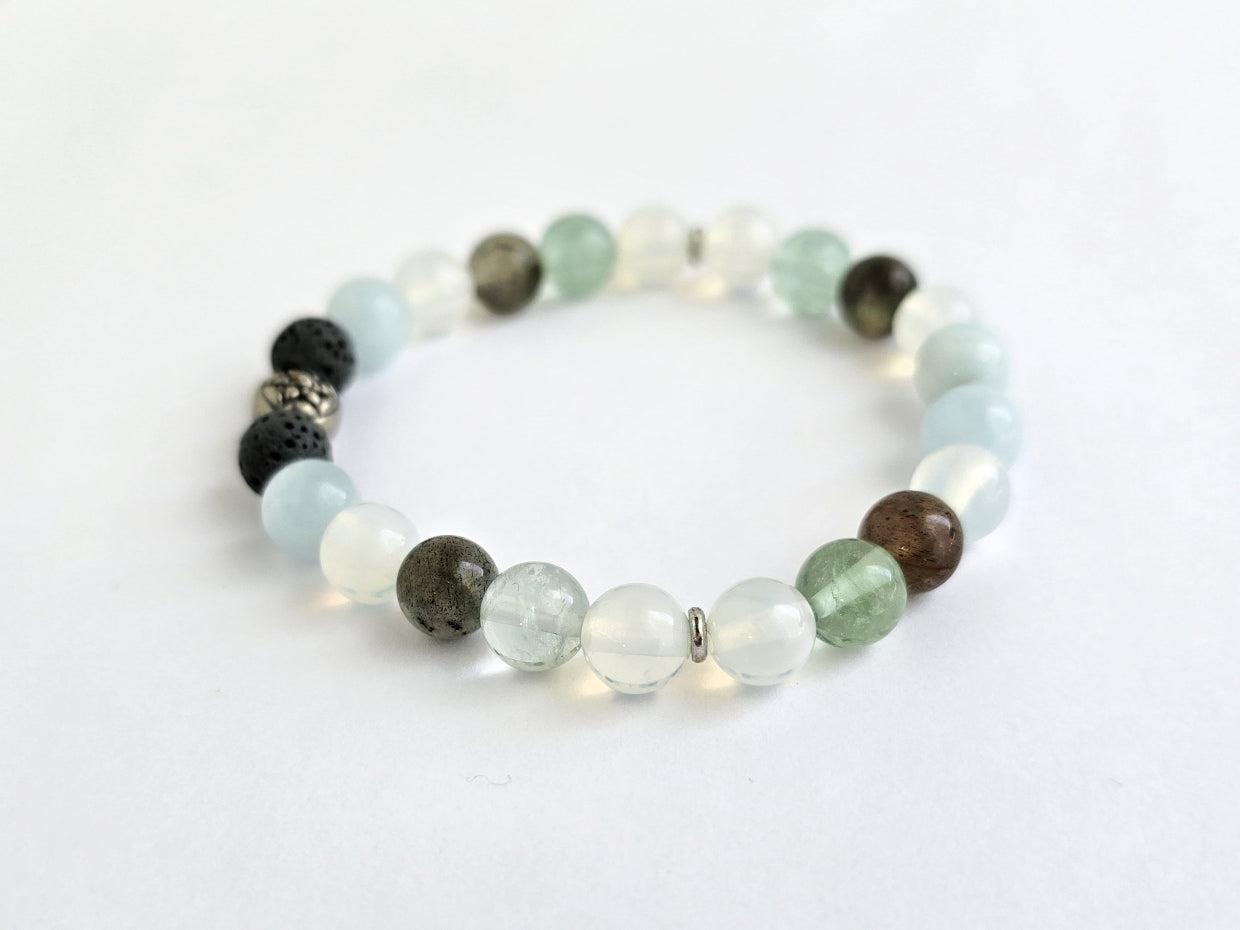 Beaded bracelet with various colored beads on a white background, featuring the text 'All is Well'.