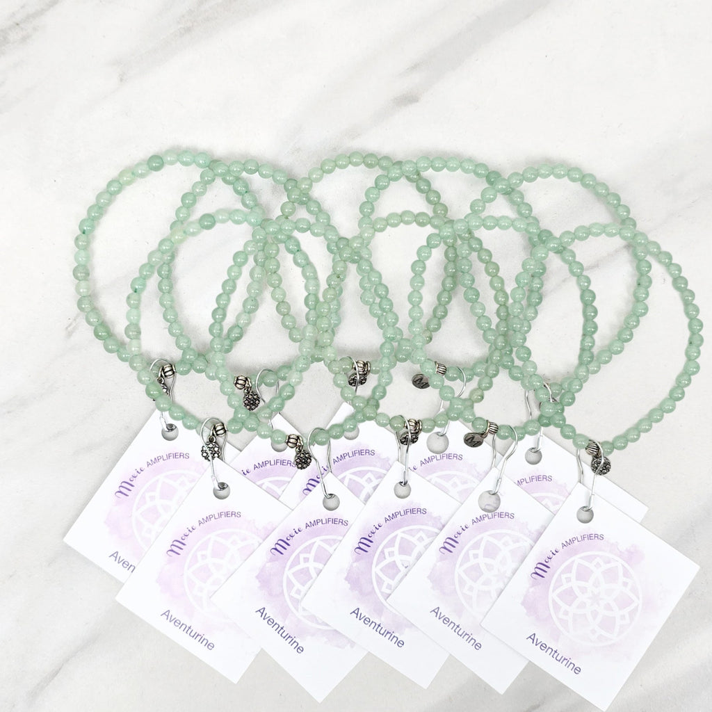 green beaded bracelets with matching cards on a marble surface galentine valentine bracelet bundle