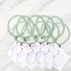green beaded bracelets with matching cards on a marble surface galentine valentine bracelet bundle