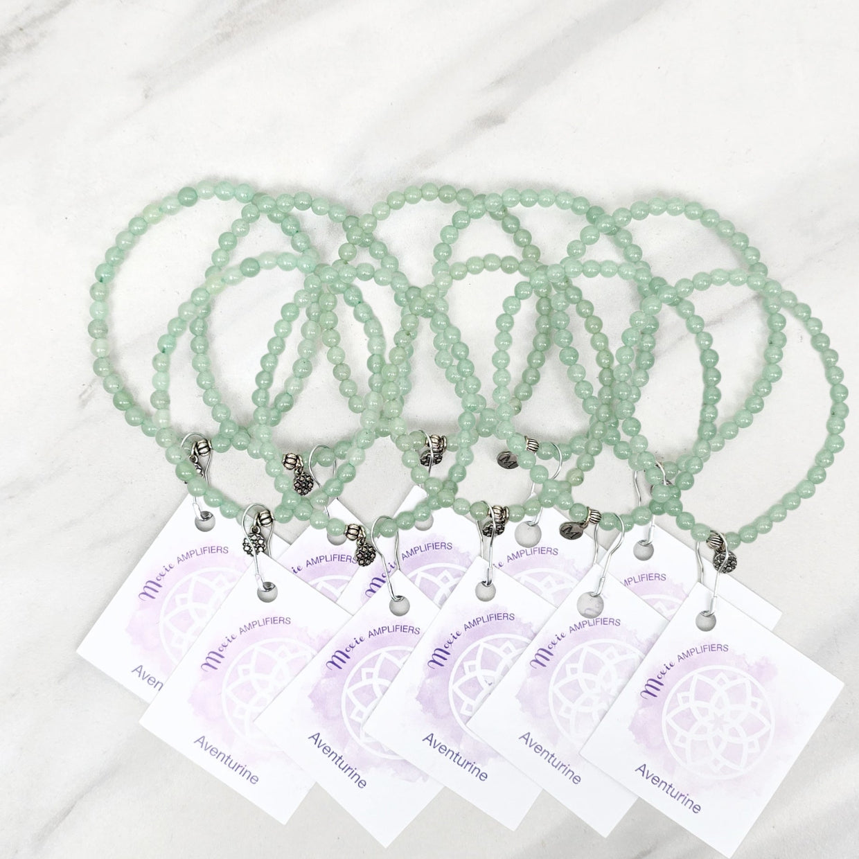 green beaded bracelets with matching cards on a marble surface galentine valentine bracelet bundle