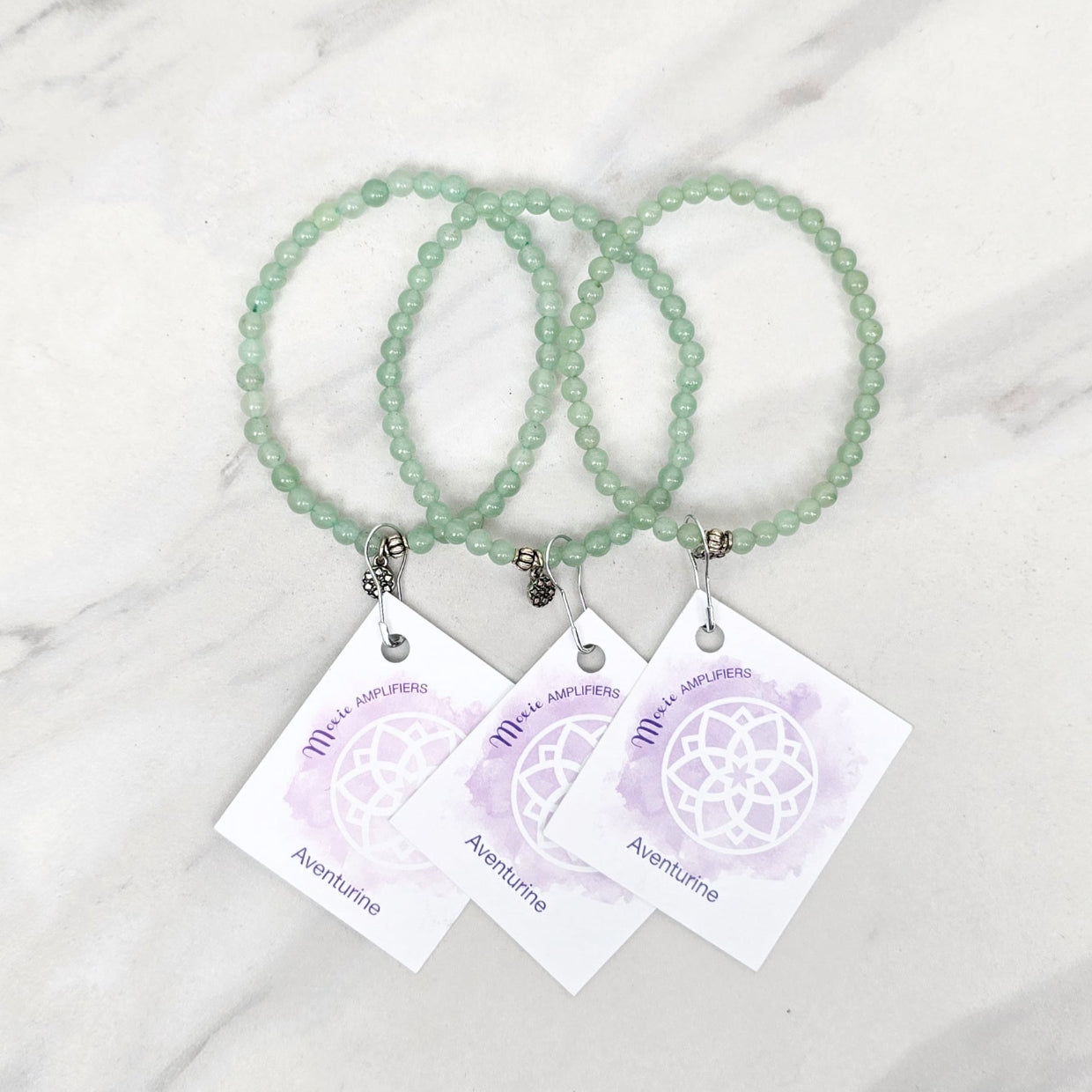 green beaded bracelets with matching cards on a marble surface galentine valentine bracelet bundle