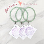 green beaded bracelets with matching cards on a marble surface galentine valentine bracelet bundle