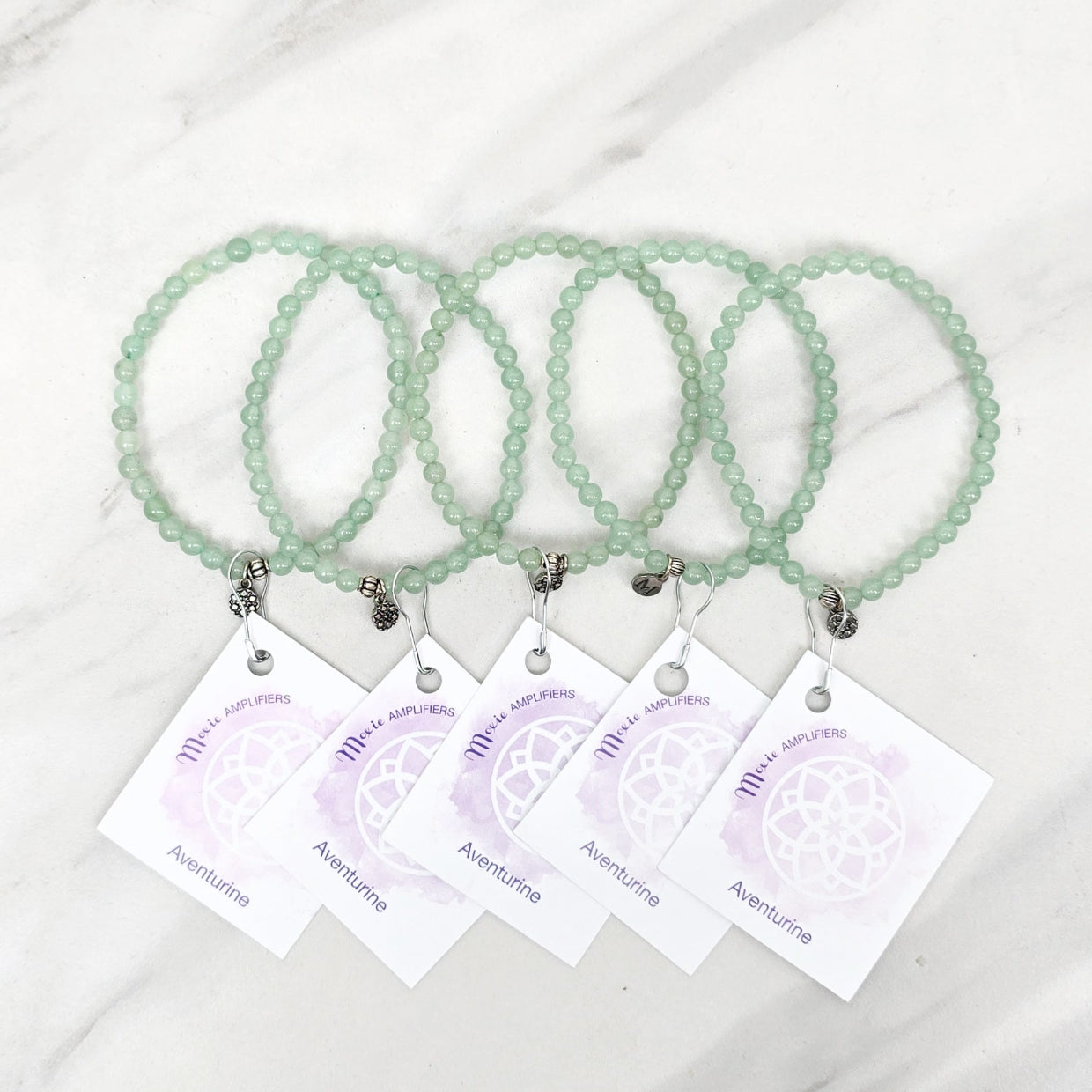 green beaded bracelets with matching cards on a marble surface galentine valentine bracelet bundle