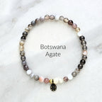 Beaded bracelet with 'Botswana Agate' text on a light background
