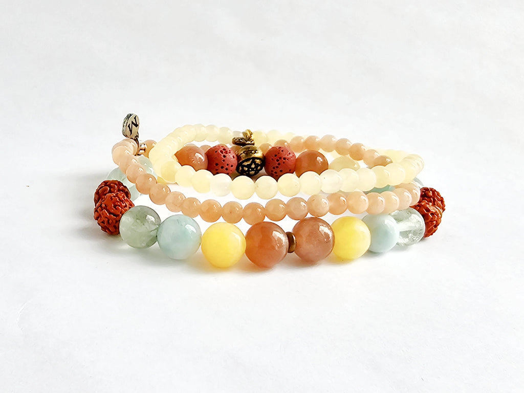 Set of multicolored beaded bracelets on a white background