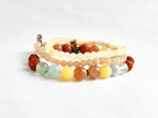 Set of multicolored beaded bracelets on a white background