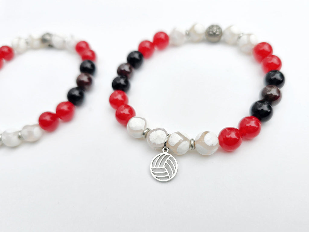 Two beaded bracelets with red, black, and white beads on a white background. Centennial Volleyball Club