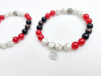 Two beaded bracelets with red, black, and white beads on a white background. Centennial Volleyball Club