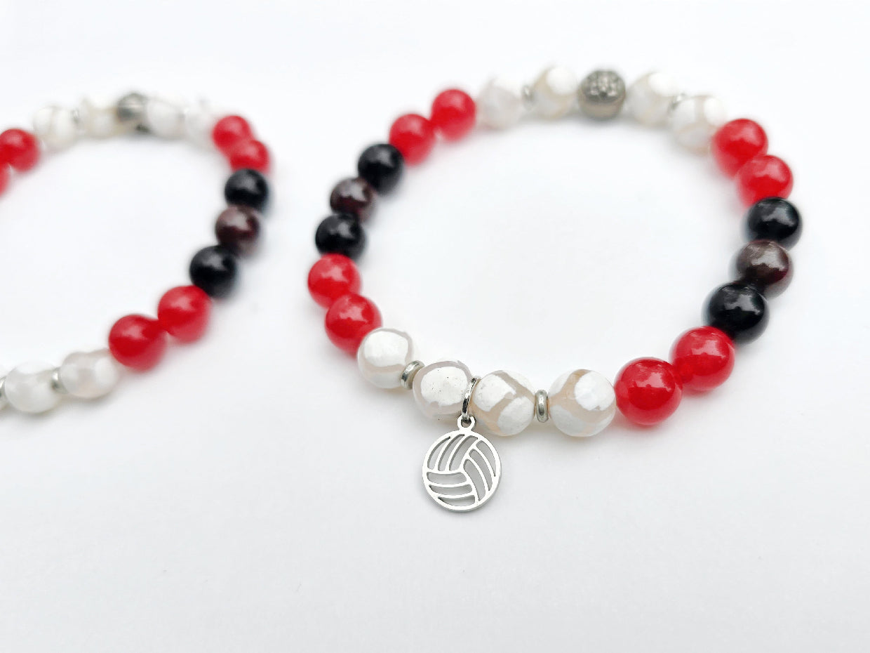 Two beaded bracelets with red, black, and white beads on a white background. Centennial Volleyball Club