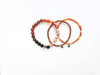 Set of three beaded bracelets on a white background