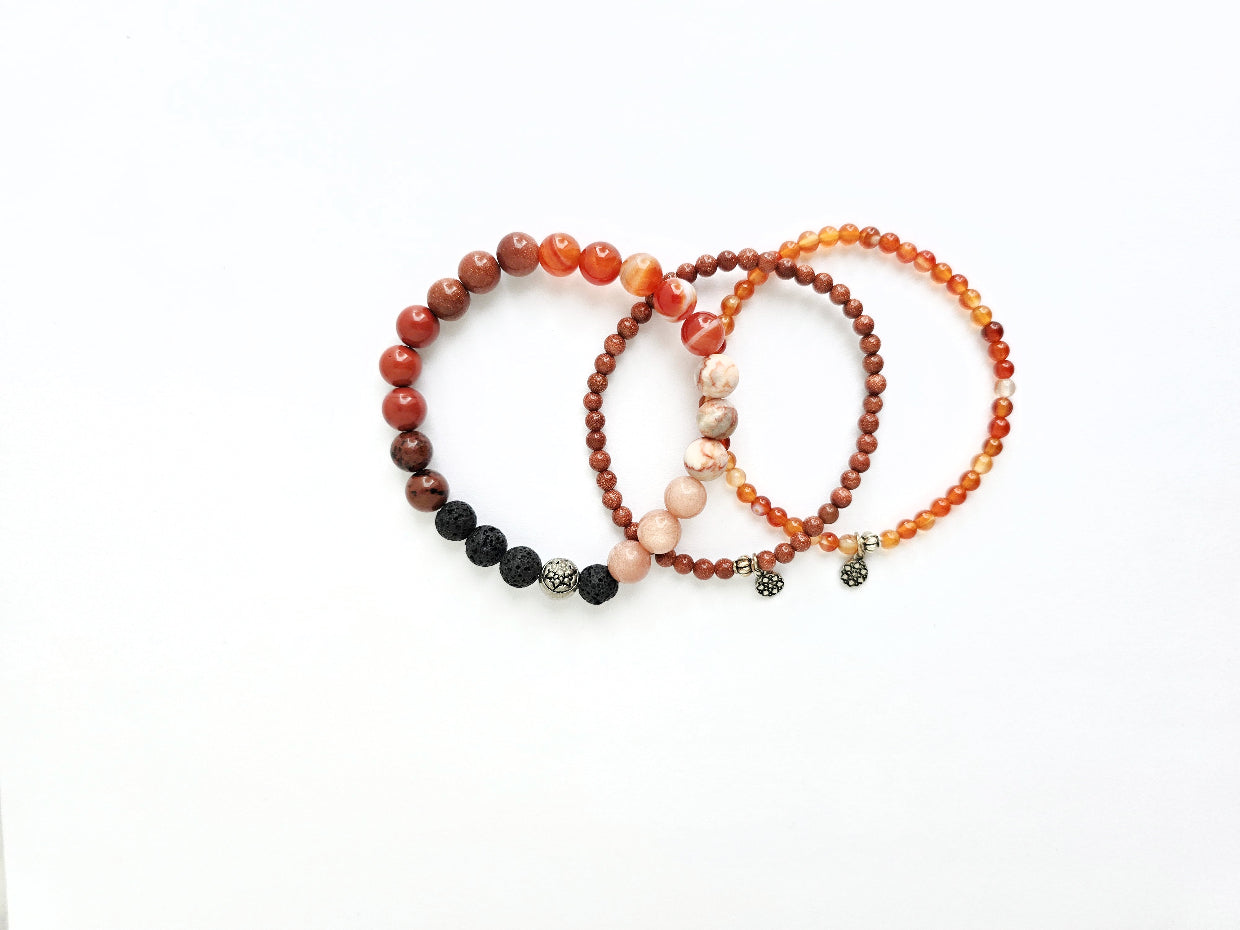 Set of three beaded bracelets on a white background