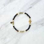 Christian Bracelet with beads and golden cross on a marble surface with Isaiah 41:10 do not be afraid courage bracelet