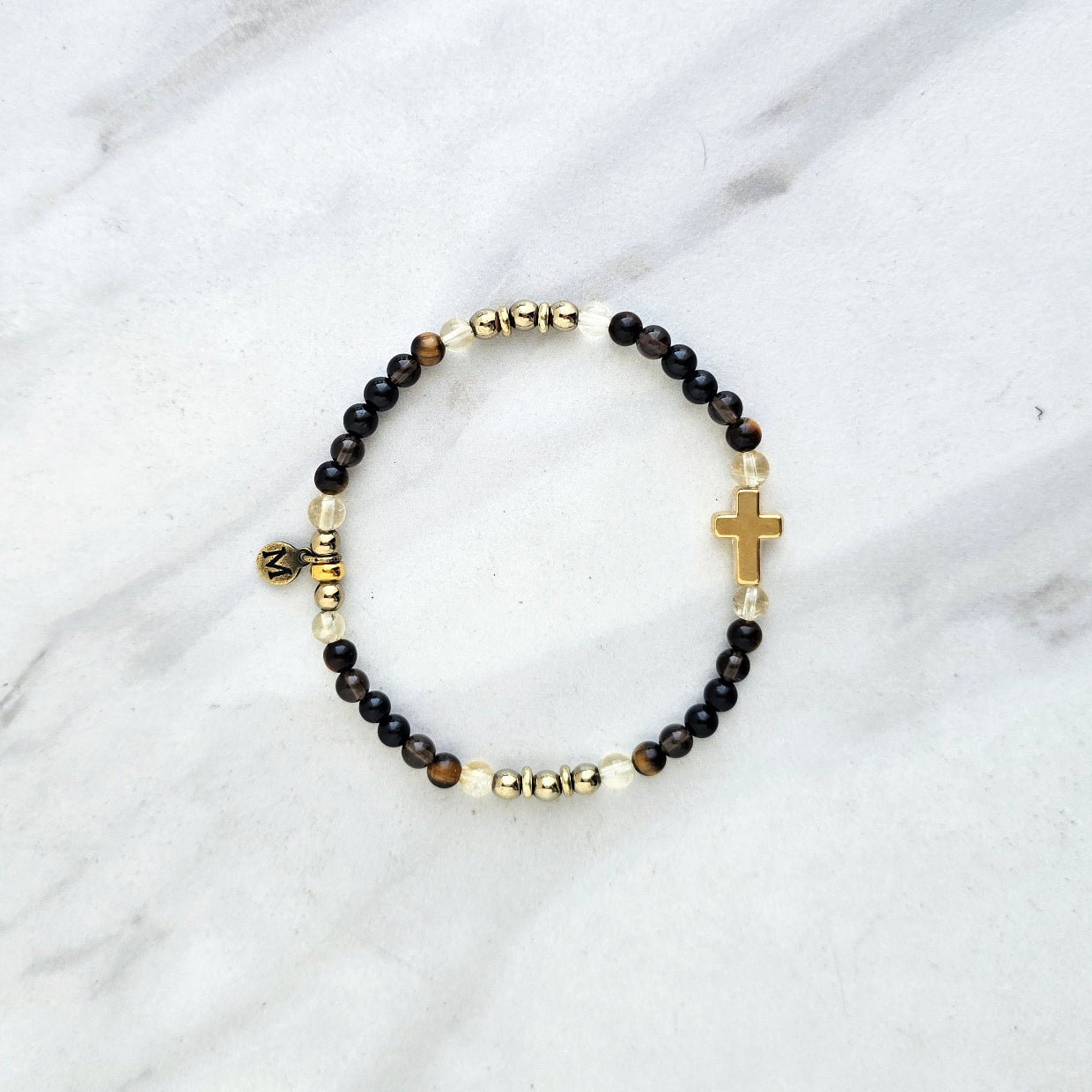 Christian Bracelet with beads and golden cross on a marble surface with Isaiah 41:10 do not be afraid courage bracelet