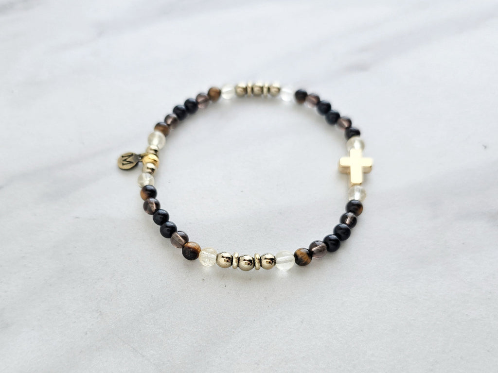 Christian Bracelet with beads and golden cross on a marble surface with Isaiah 41:10 do not be afraid courage bracelet