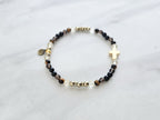 Christian Bracelet with beads and golden cross on a marble surface with Isaiah 41:10 do not be afraid courage bracelet
