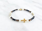 Christian Bracelet with beads and golden cross on a marble surface with Isaiah 41:10 do not be afraid courage bracelet