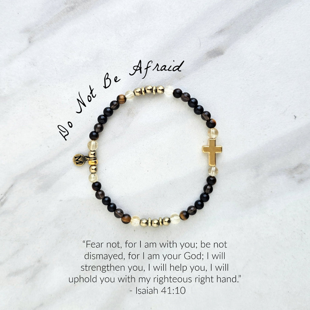 Christian Bracelet with beads and golden cross on a marble surface with Isaiah 41:10 do not be afraid courage bracelet