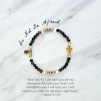 Christian Bracelet with beads and golden cross on a marble surface with Isaiah 41:10 do not be afraid courage bracelet