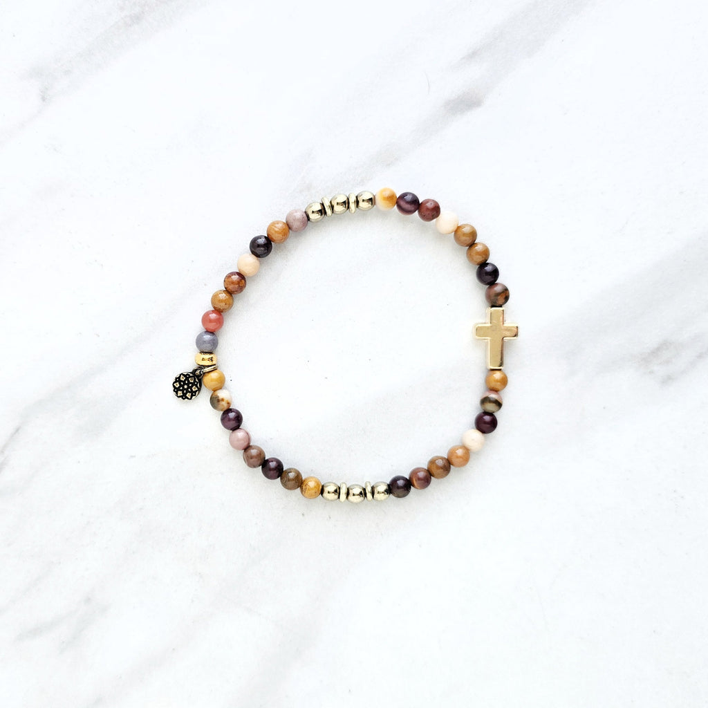 Christian Beaded bracelet with golden cross charm on a white background, featuring a quote from Matthew 6:34. stress and anxiety relief