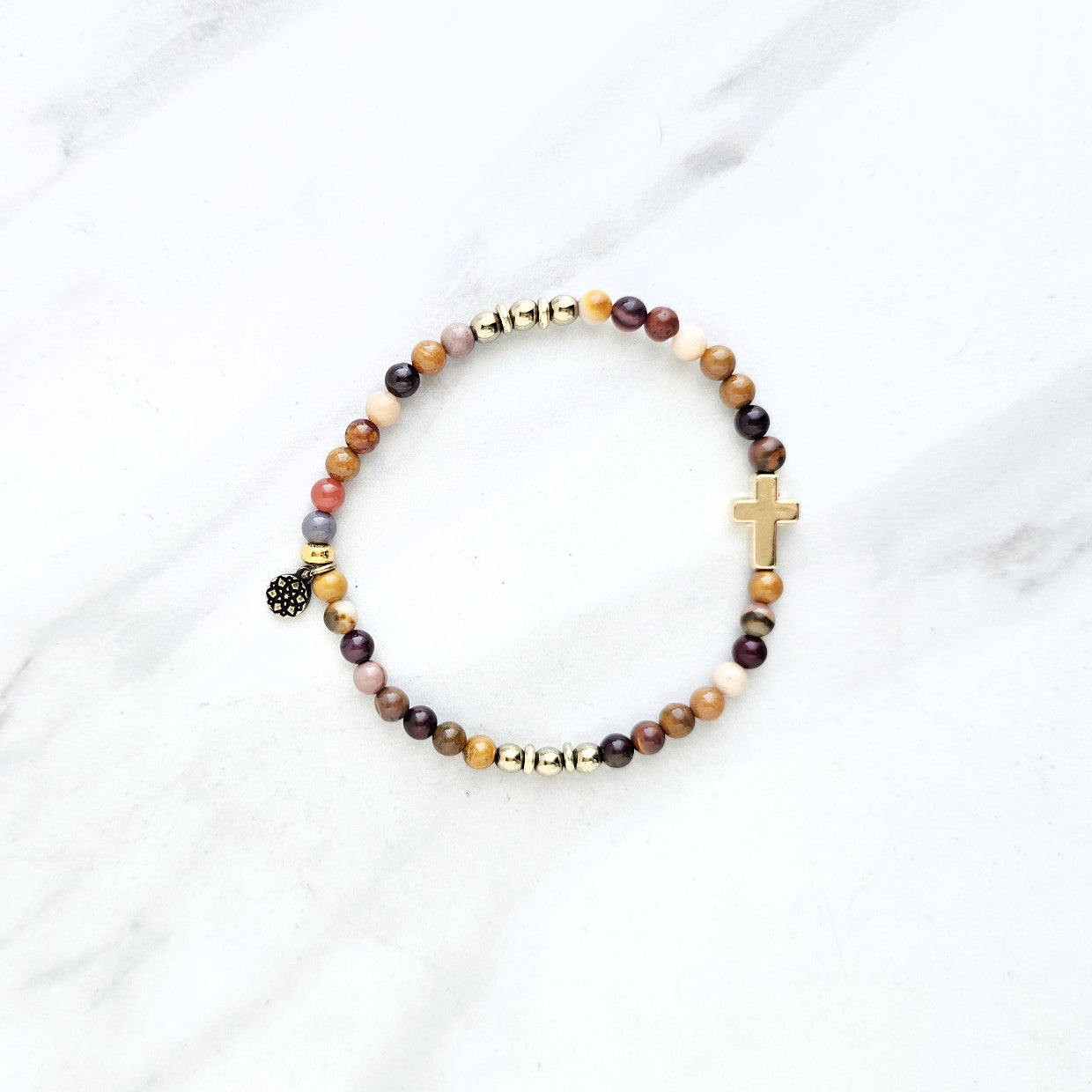 Christian Beaded bracelet with golden cross charm on a white background, featuring a quote from Matthew 6:34. stress and anxiety relief