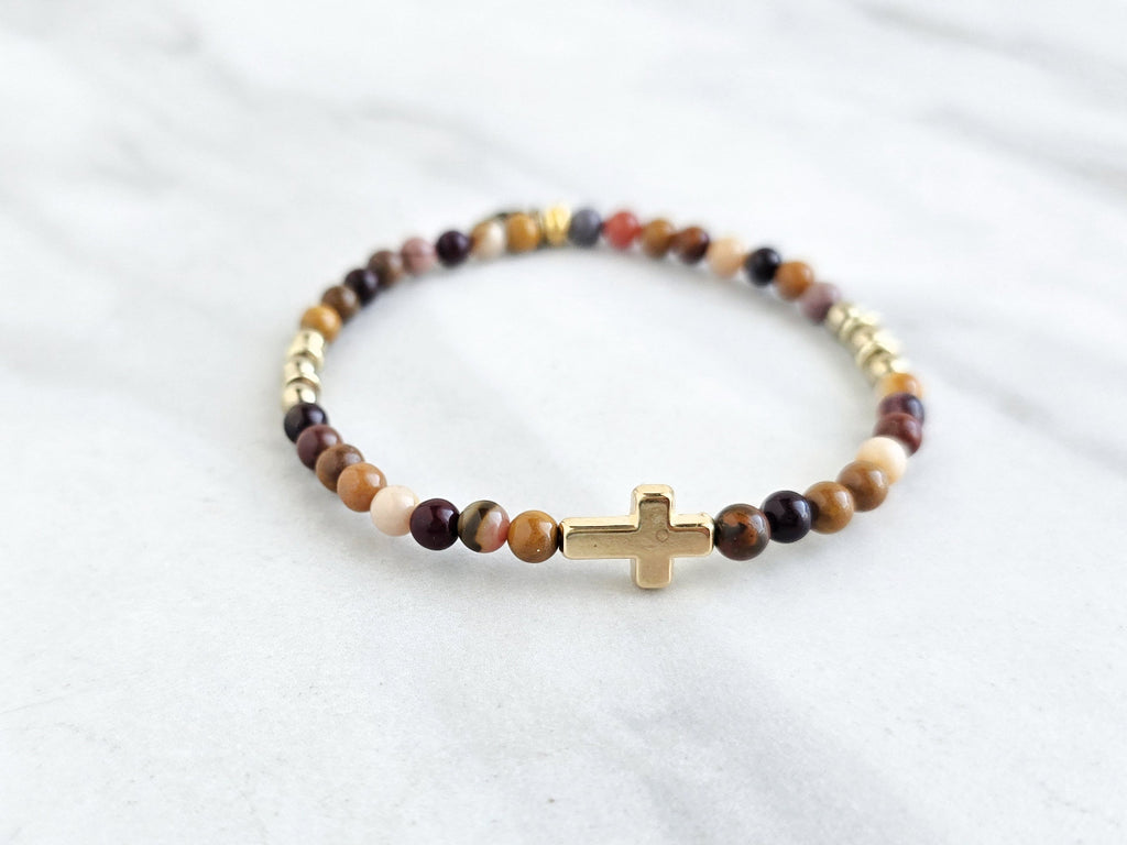 Christian Beaded bracelet with golden cross charm on a white background, featuring a quote from Matthew 6:34. stress and anxiety relief