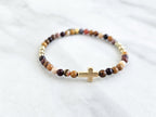 Christian Beaded bracelet with golden cross charm on a white background, featuring a quote from Matthew 6:34. stress and anxiety relief