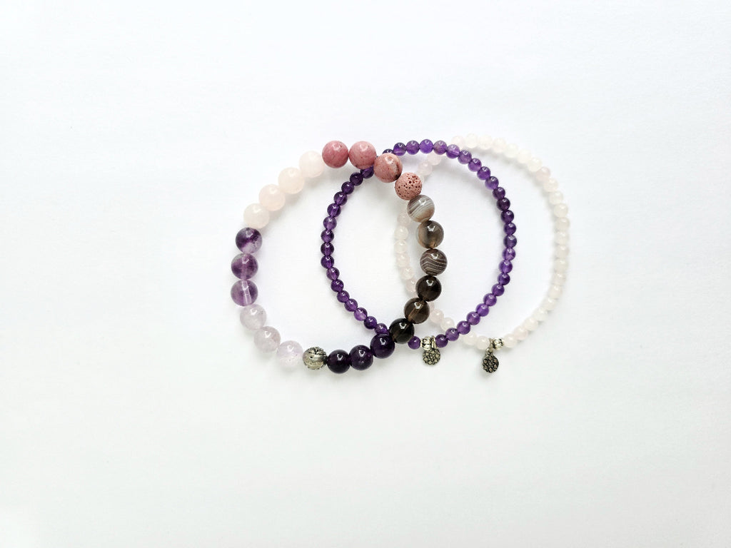 Set of three beaded bracelets on a white background