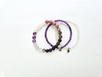 Set of three beaded bracelets on a white background