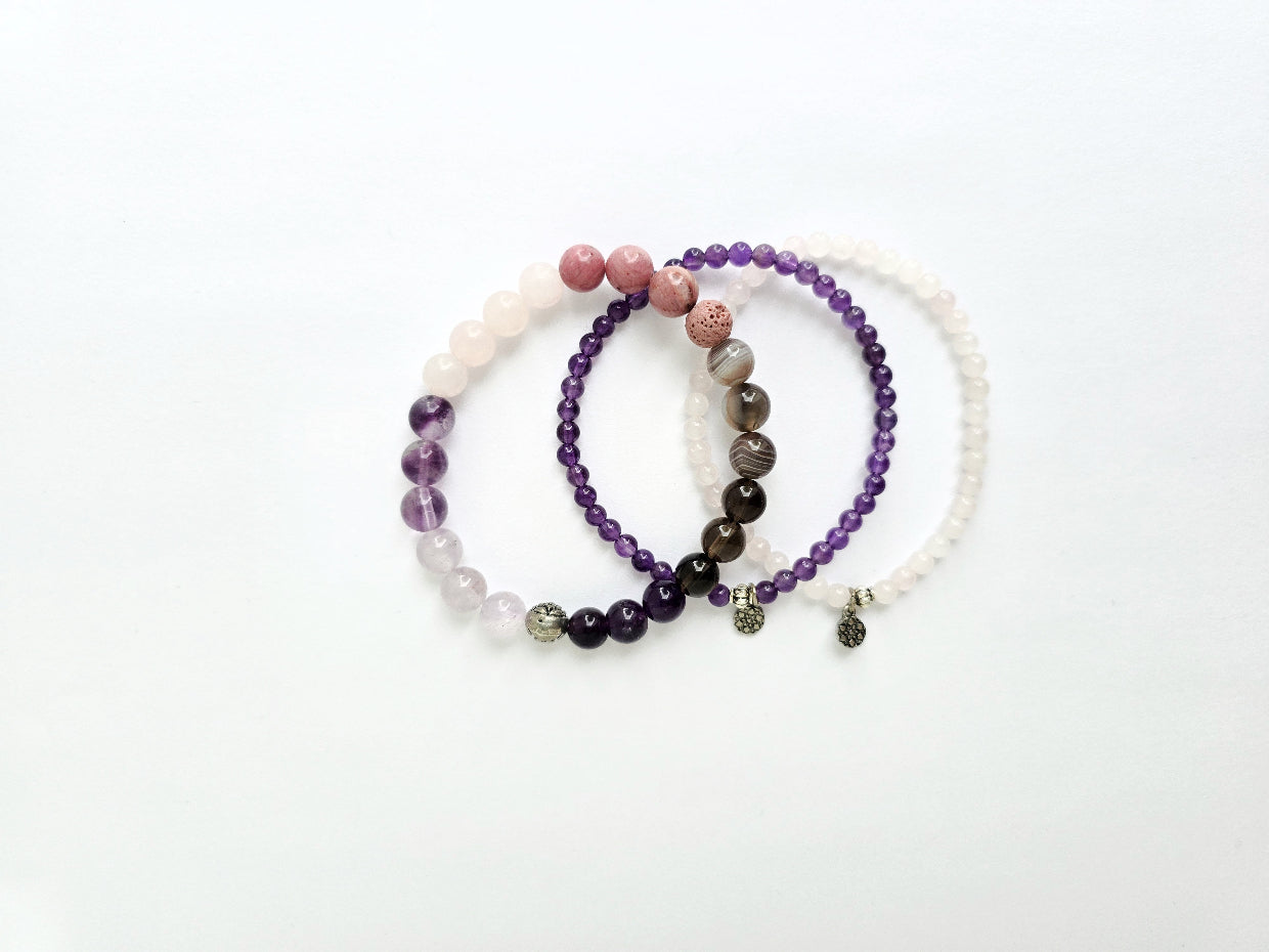 Set of three beaded bracelets on a white background