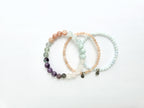 Set of three beaded bracelets on a white background