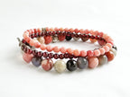 Set of multicolored beaded bracelets on a white background