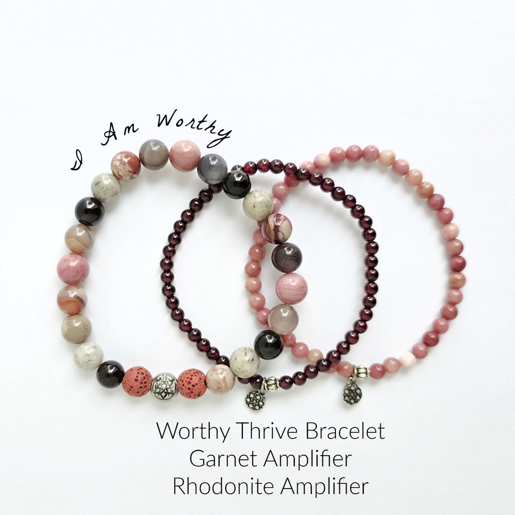 Set of beaded bracelets with garnet and rhodonite stones on a white background