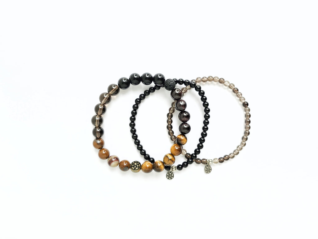 Set of three beaded bracelets on a white background