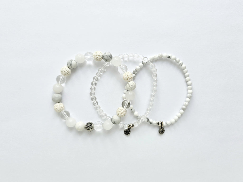 Three beaded bracelets on a light gray background