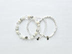 Three beaded bracelets on a light gray background