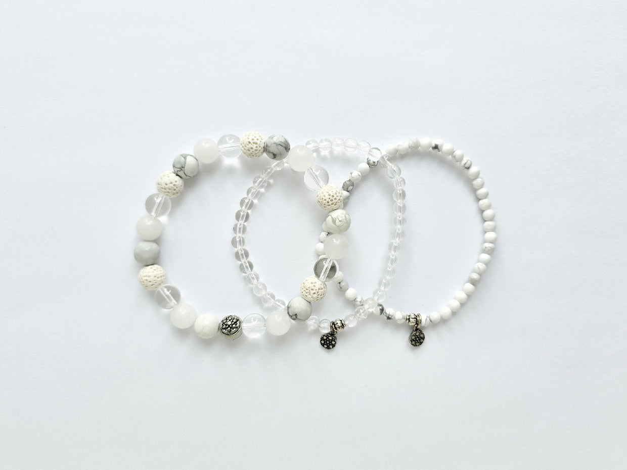 Three beaded bracelets on a light gray background