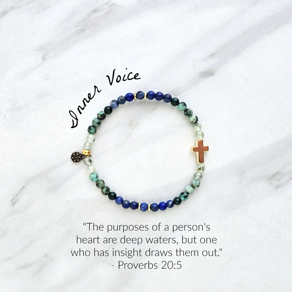 Beaded bracelet with a golden cross on a white marble background, featuring a quote from Proverbs 20:5. Christian Bracelet