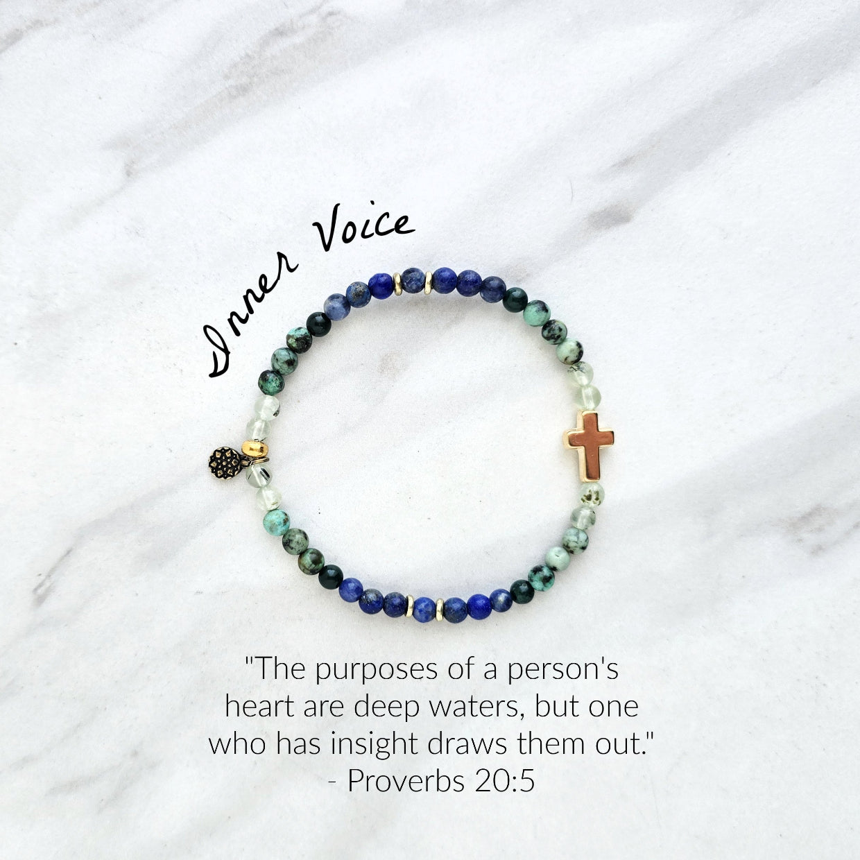 Beaded bracelet with a golden cross on a white marble background, featuring a quote from Proverbs 20:5. Christian Bracelet