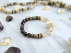 Bracelet with stones and beads on a marble surface with 'Moxie Monthly' branding. planting the seed january 2026 bracelet club