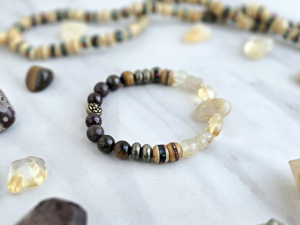 Bracelet with stones and beads on a marble surface with 'Moxie Monthly' branding. planting the seed january 2026 bracelet club