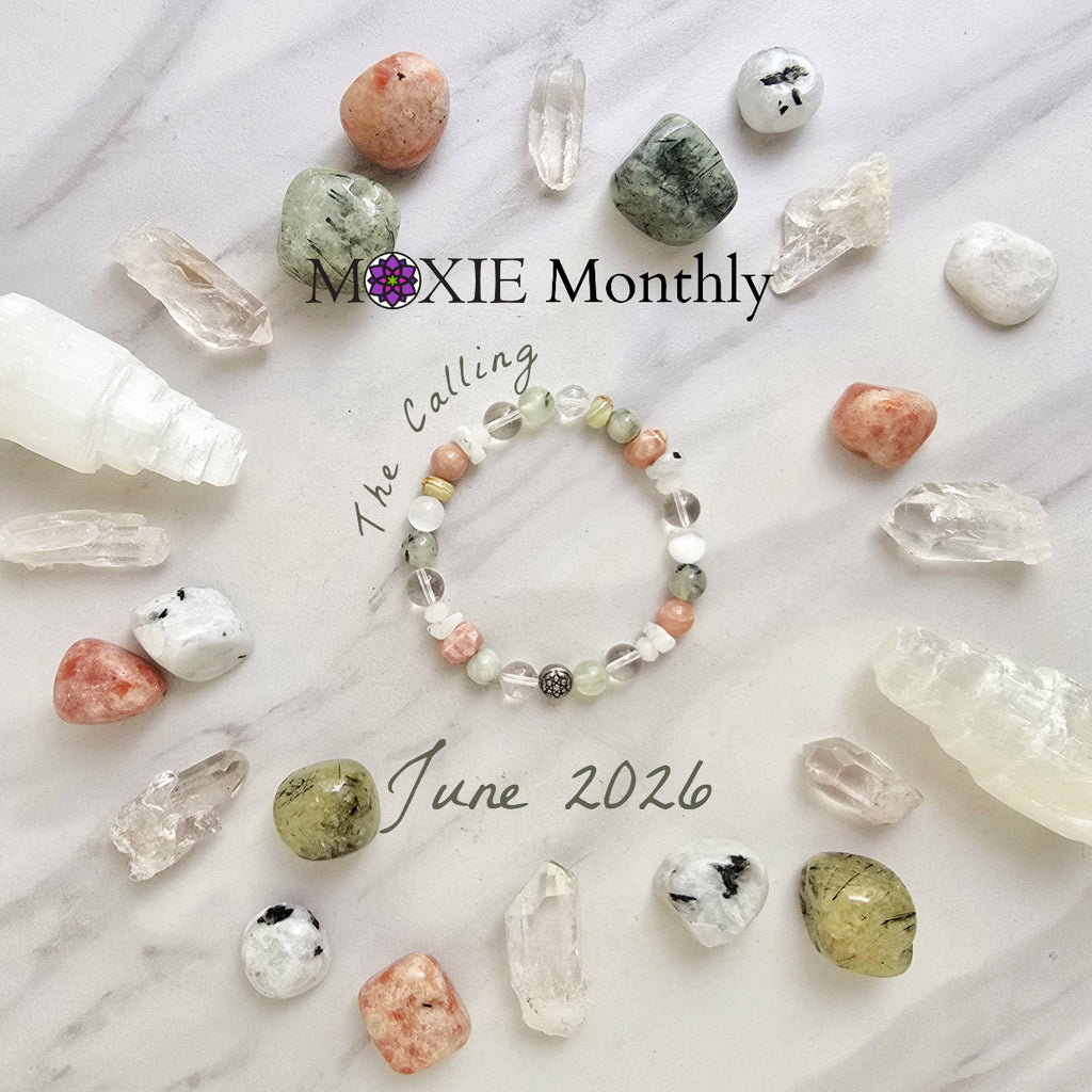 Crystal bracelet with stones on a marble surface, featuring 'Moxie Monthly' branding. June 2026 the calling