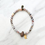 mn state brass charm botswana agate beads with lake superior stone bracelet on a white background