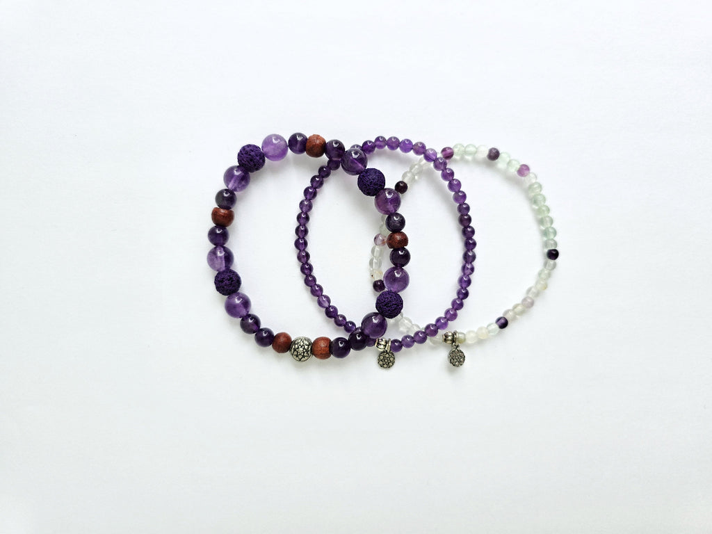 Three beaded bracelets on a white background