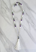 Beaded necklace with a tassel on a marble surface metatron meditation beads mala