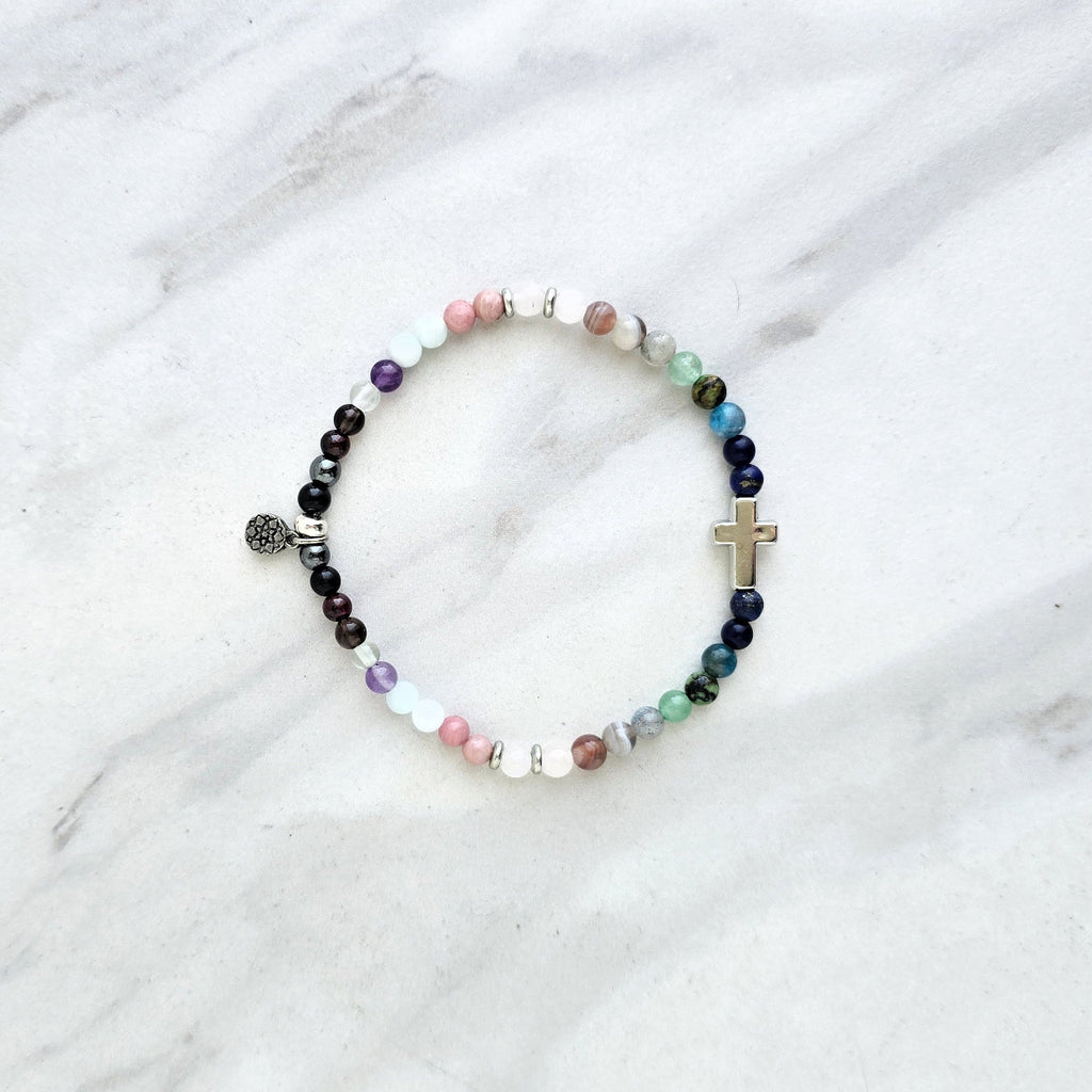 multi color crystal and stone Christian bracelet on a white marble background john 14:27 peace i give you