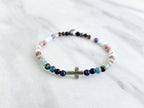 multi color crystal and stone Christian bracelet on a white marble background john 14:27 peace i give you