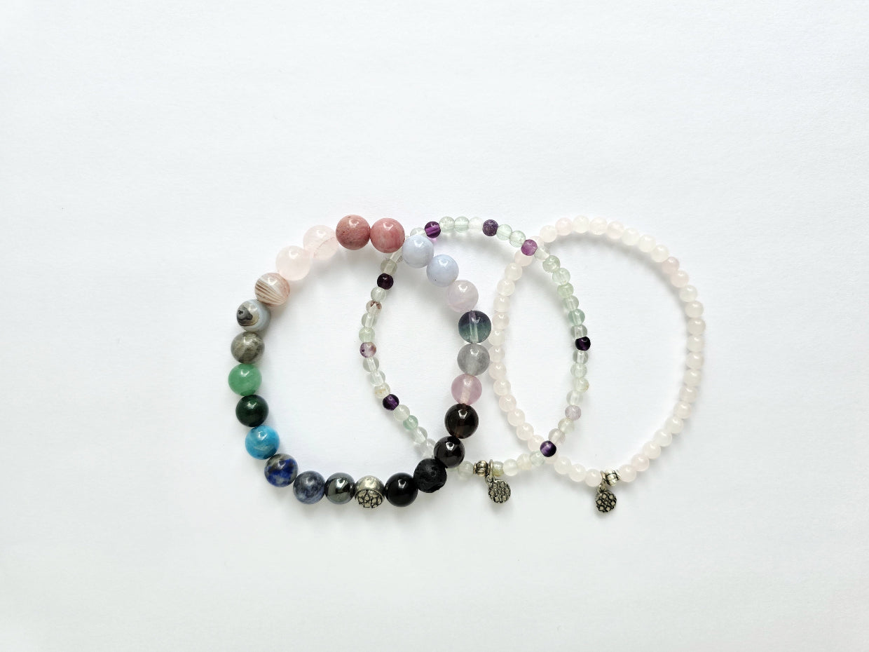 Three beaded bracelets on a white background